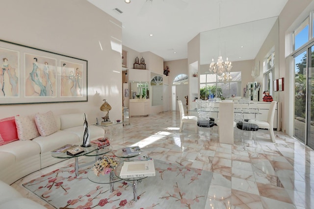 unfurnished living room featuring a towering ceiling and an inviting chandelier