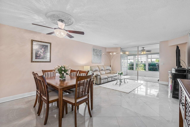 dining area featuring ceiling fan and a textured ceiling