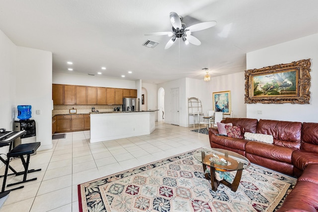 tiled living room featuring ceiling fan