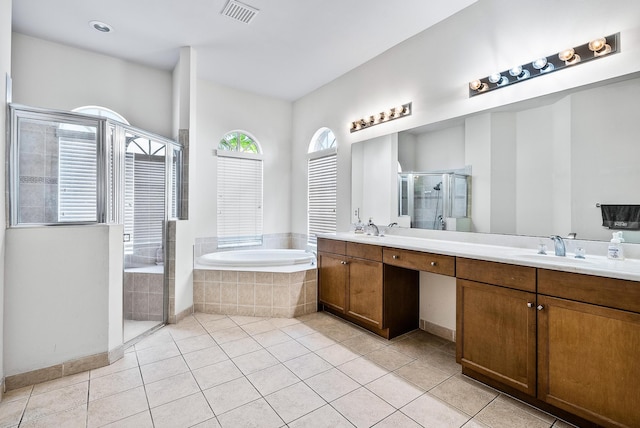 bathroom with tile patterned floors, vanity, and shower with separate bathtub