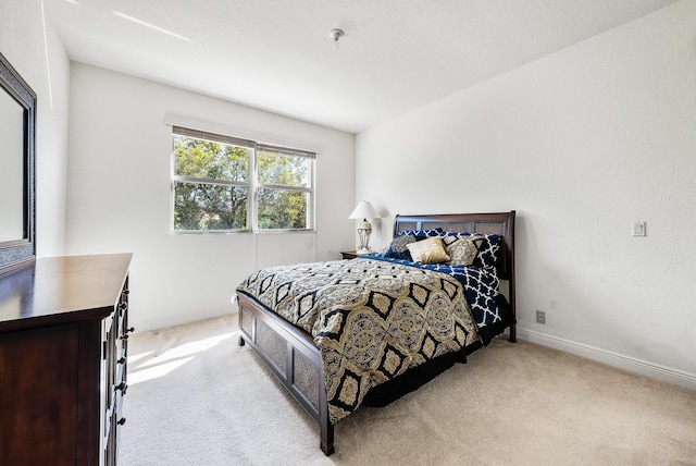 bedroom featuring light colored carpet