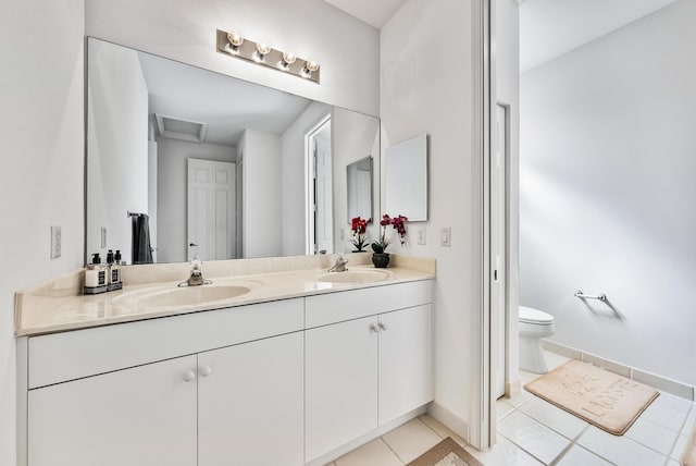 bathroom featuring tile patterned floors, vanity, and toilet