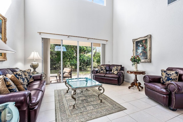 tiled living room with a towering ceiling and a wealth of natural light