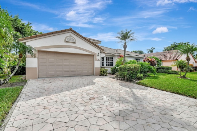 view of front of home featuring a front yard and a garage