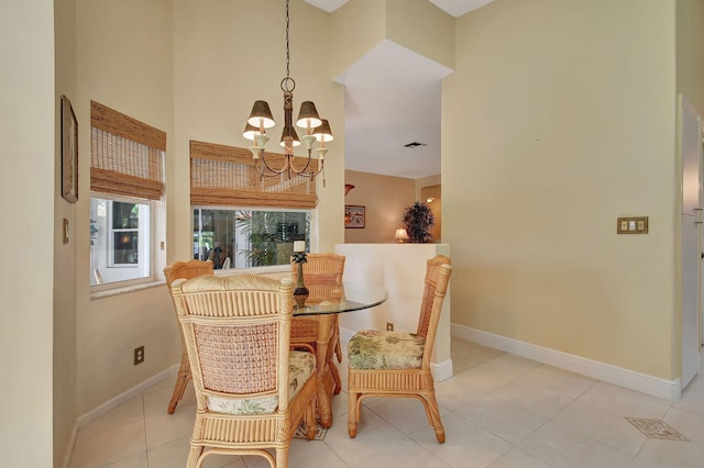 tiled dining room with an inviting chandelier