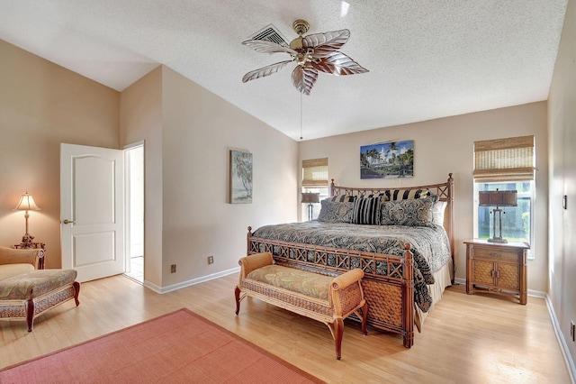 bedroom featuring light wood-type flooring, vaulted ceiling, and ceiling fan