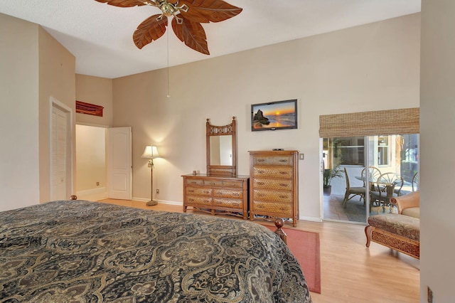 bedroom with access to exterior, light hardwood / wood-style floors, and ceiling fan