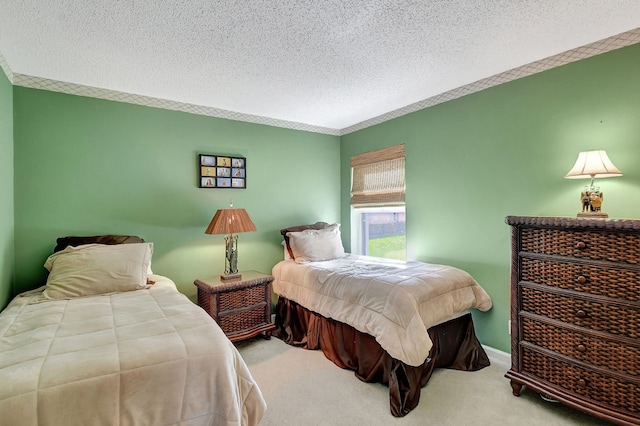 bedroom featuring light colored carpet and a textured ceiling