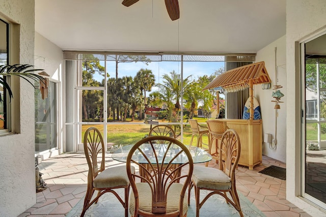 sunroom / solarium featuring ceiling fan