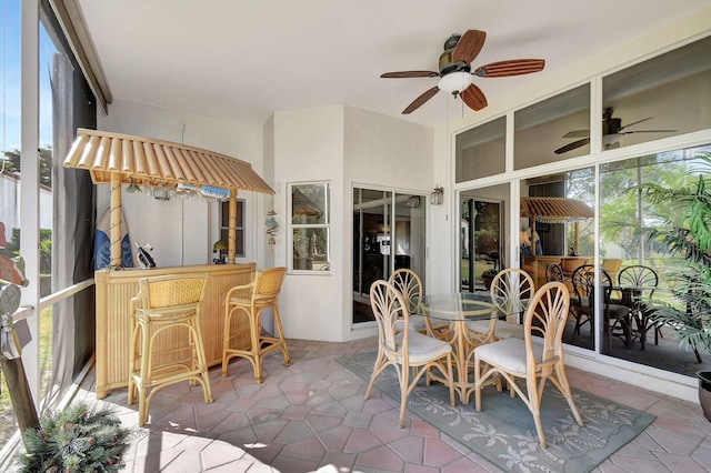 sunroom featuring ceiling fan