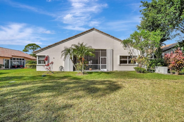 back of property featuring a lawn