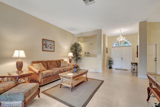 tiled living room featuring a notable chandelier