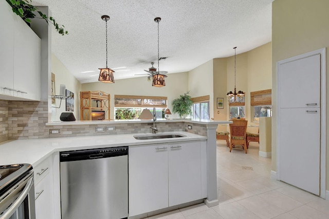 kitchen featuring white cabinetry, hanging light fixtures, stainless steel appliances, and sink