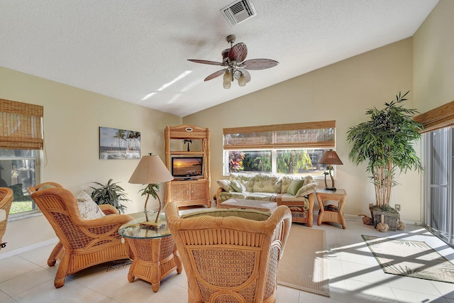 interior space with a textured ceiling, ceiling fan, and vaulted ceiling