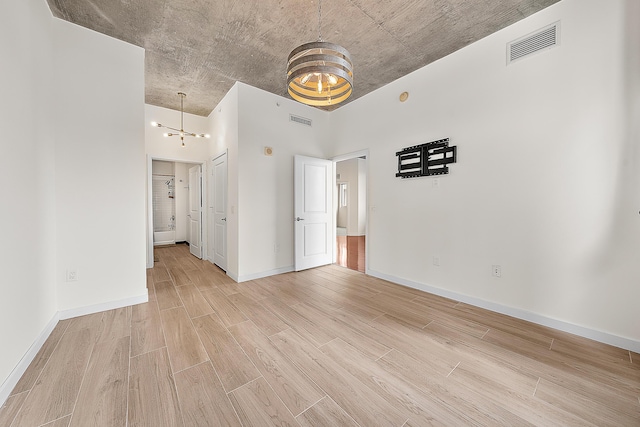 300 S Australian Ave Unit 520, West Palm Beach, FL 33401 - unfurnished bedroom with light wood finished floors, baseboards, and connected bathroom