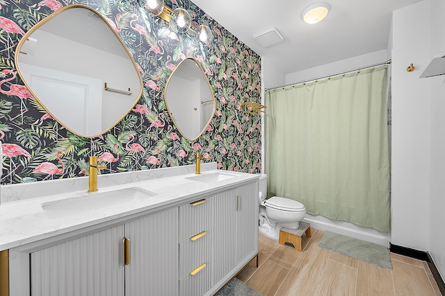 300 S Australian Ave Unit 520, West Palm Beach, FL 33401 - full bathroom with wallpapered walls, double vanity, toilet, wood finished floors, and shower / tub combo with curtain