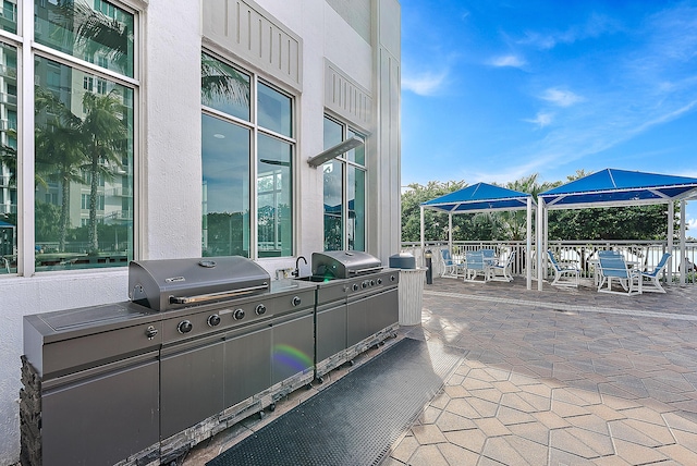 view of patio / terrace with a gazebo, area for grilling, and a grill