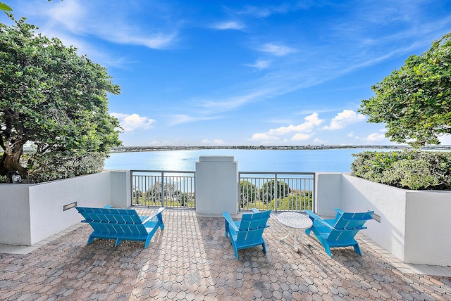 view of patio with a water view