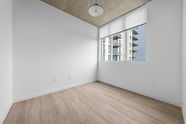 300 S Australian Ave Unit 520, West Palm Beach, FL 33401 - spare room featuring wood finished floors and baseboards