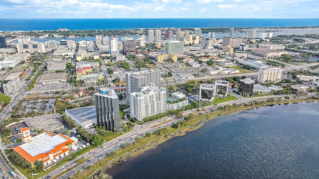 birds eye view of property with a water view and a city view