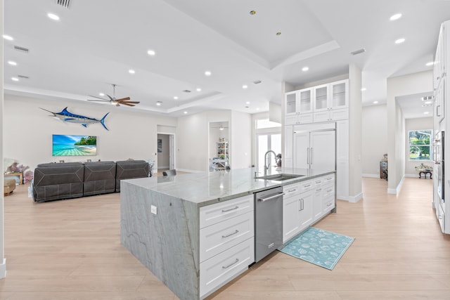 kitchen featuring a center island with sink, white cabinetry, a healthy amount of sunlight, and sink