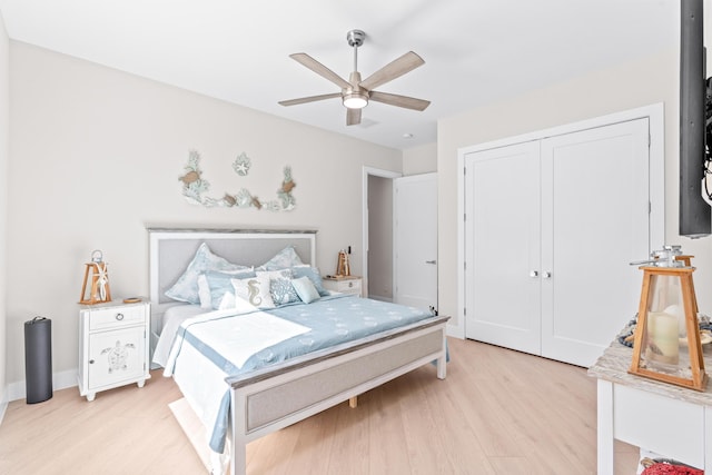 bedroom with a closet, ceiling fan, and light hardwood / wood-style flooring