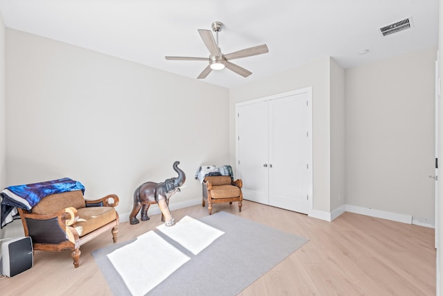 living area featuring ceiling fan and light hardwood / wood-style flooring