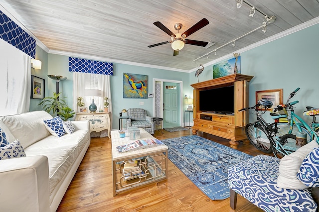 living room featuring hardwood / wood-style floors, rail lighting, ceiling fan, and crown molding