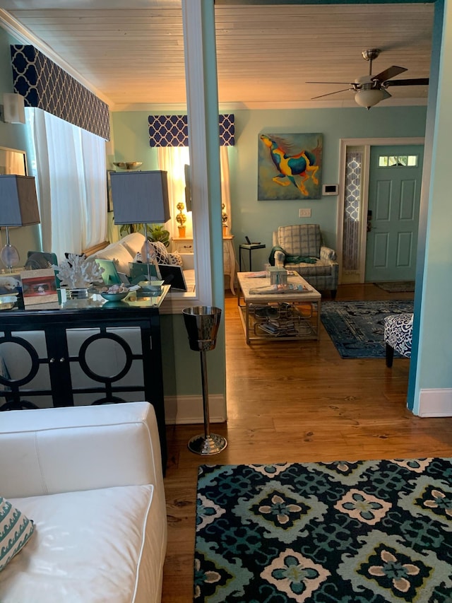 interior space with ceiling fan, hardwood / wood-style floors, and ornamental molding