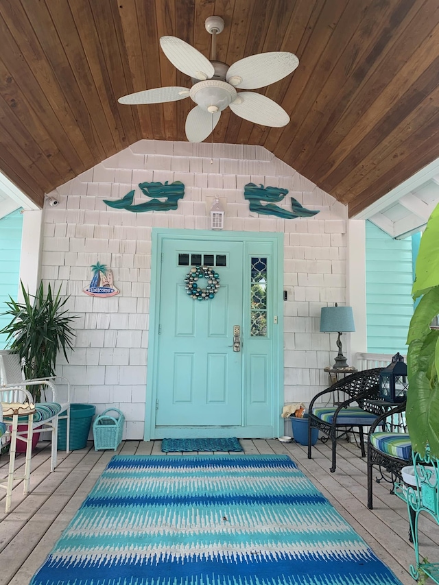 entrance to property with ceiling fan and a wooden deck