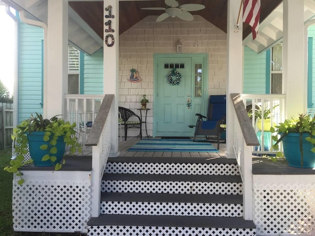 entrance to property with ceiling fan and a porch