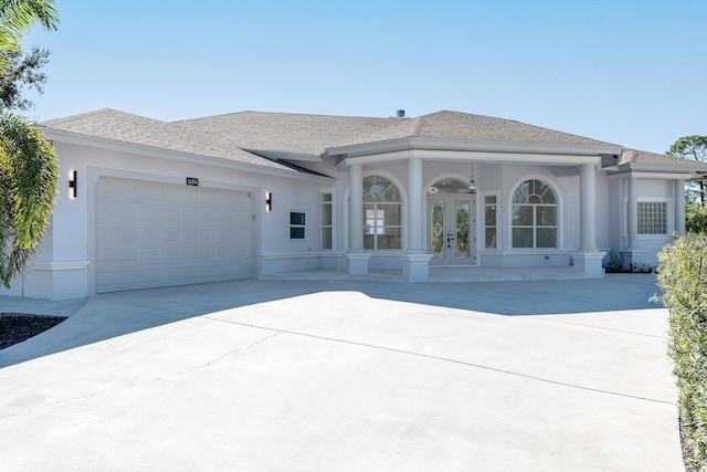 view of front of house featuring a garage and french doors