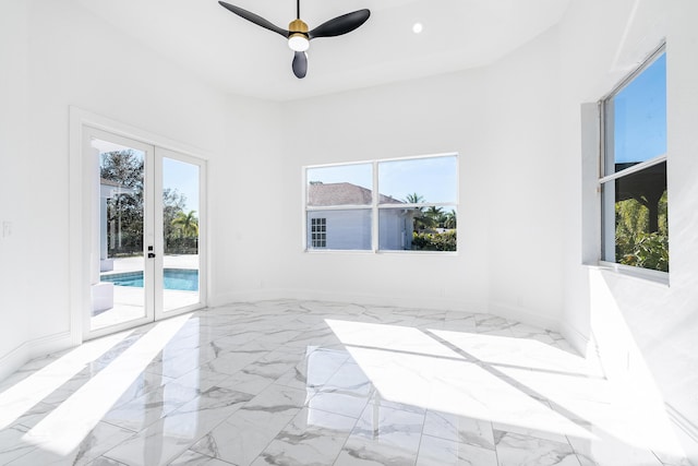 empty room featuring french doors and ceiling fan