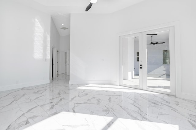 spare room featuring ceiling fan and french doors