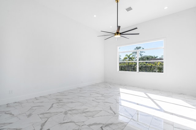 empty room featuring vaulted ceiling and ceiling fan