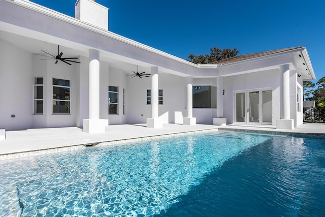 view of pool with french doors, ceiling fan, and a patio area