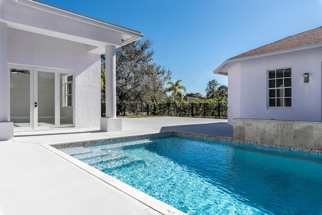 view of pool featuring a patio and french doors