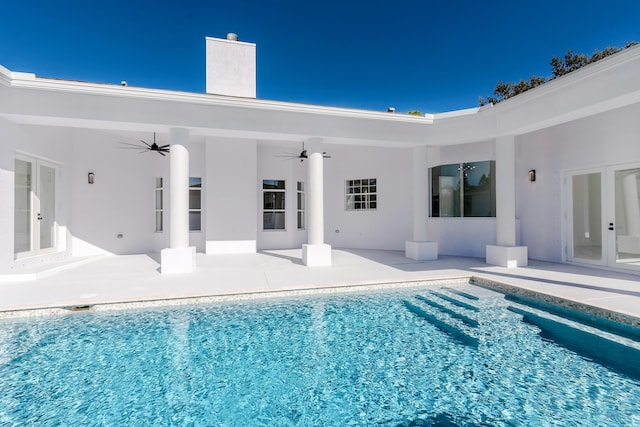 view of pool with french doors, a patio, and ceiling fan