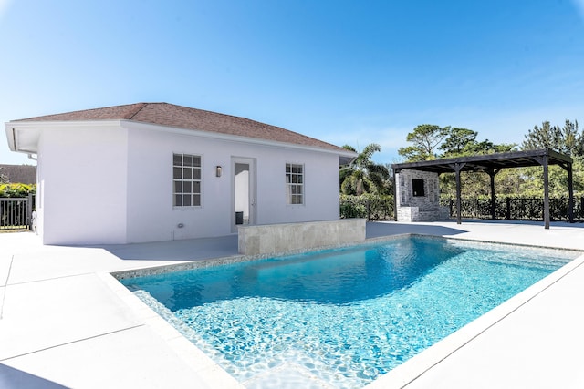 view of swimming pool featuring a patio and an outdoor structure