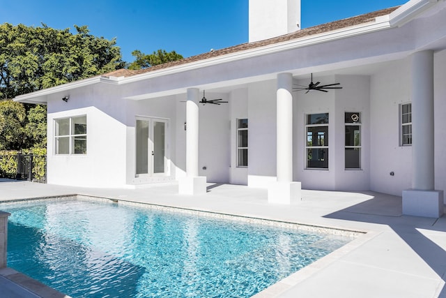 view of swimming pool featuring french doors, a patio, and ceiling fan