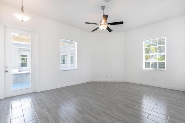 unfurnished room with hardwood / wood-style floors and ceiling fan