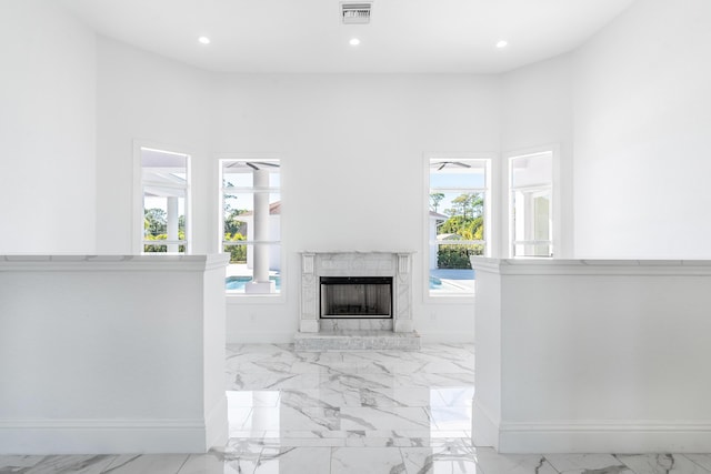 unfurnished living room featuring a premium fireplace