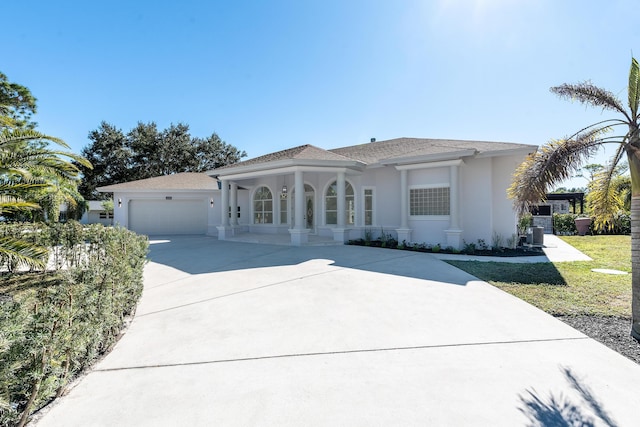 mediterranean / spanish home with a garage and a front lawn