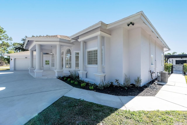 view of side of home featuring a garage and central air condition unit