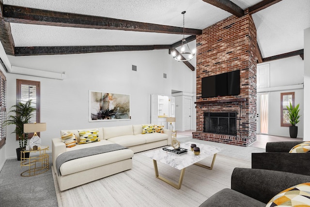 living room featuring a textured ceiling, an inviting chandelier, high vaulted ceiling, and a healthy amount of sunlight