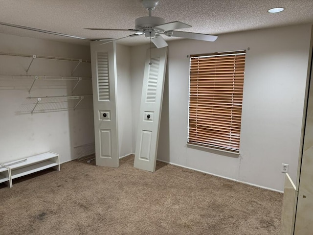 unfurnished bedroom with a ceiling fan, a closet, carpet flooring, and a textured ceiling