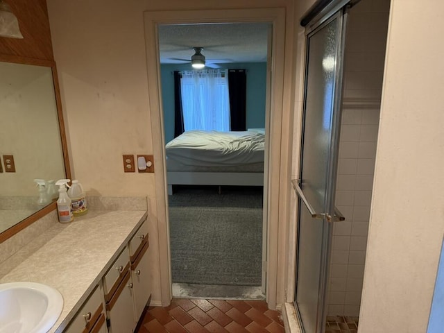 bathroom featuring connected bathroom, a shower stall, vanity, and ceiling fan