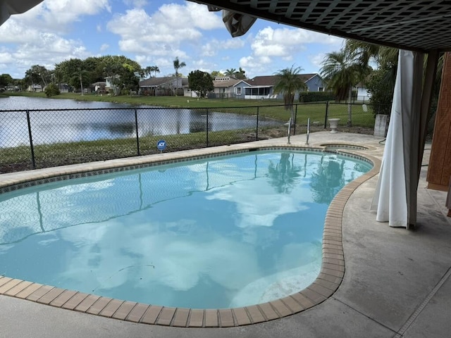 view of swimming pool with a water view, fence, and a fenced in pool