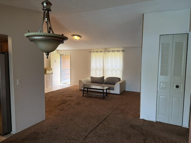 carpeted living room with a textured ceiling