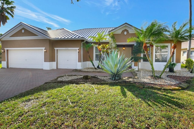 view of front of property featuring a garage and a front lawn